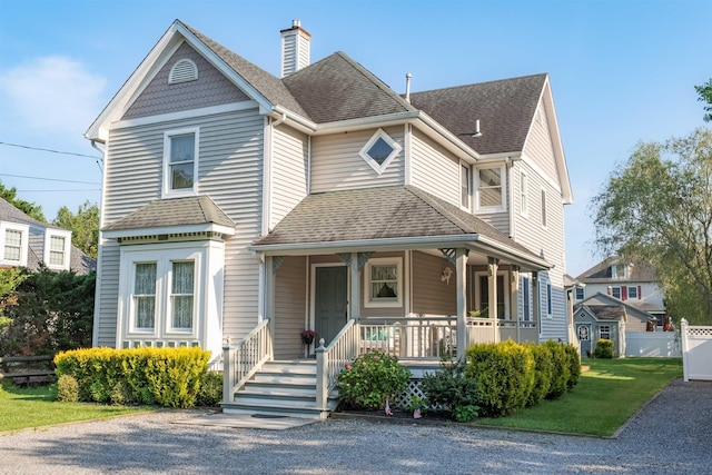 119 Stevens St, West Cape May, NJ 08204 - victorian house featuring covered porch, a shingled roof, and a chimney