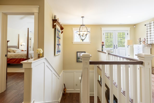 310 Brainard Ave, Cape May Point, NJ 08212 - stairway featuring wood finished floors, wainscoting, a chandelier, and a decorative wall