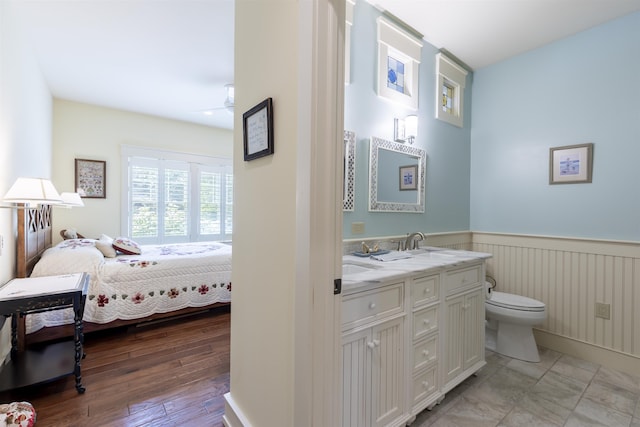 310 Brainard Ave, Cape May Point, NJ 08212 - full bathroom with toilet, wainscoting, ensuite bath, double vanity, and a ceiling fan