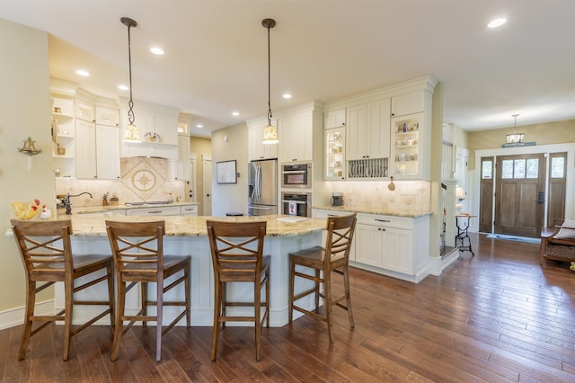 310 Brainard Ave, Cape May Point, NJ 08212 - kitchen featuring appliances with stainless steel finishes, a peninsula, tasteful backsplash, glass insert cabinets, and recessed lighting