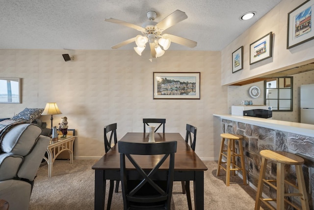 14 Genoa Ct Unit 14, Ocean City, NJ 08226 - carpeted dining space with a bar, baseboards, a ceiling fan, and a textured ceiling