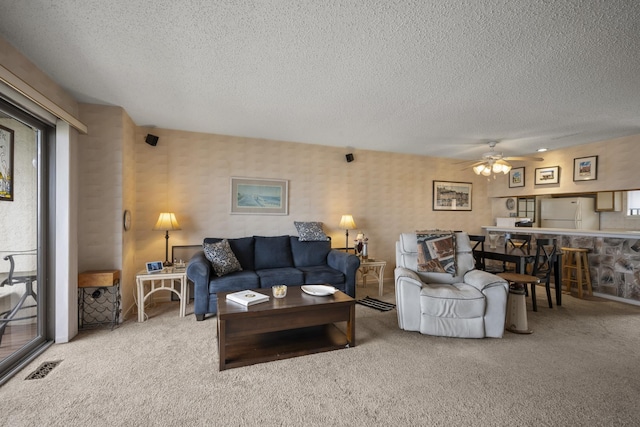 14 Genoa Ct Unit 14, Ocean City, NJ 08226 - living area with a textured ceiling, visible vents, carpet, wallpapered walls, and ceiling fan