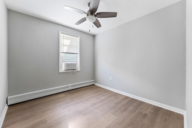 unfurnished room with light hardwood / wood-style flooring, ceiling fan, and a baseboard heating unit