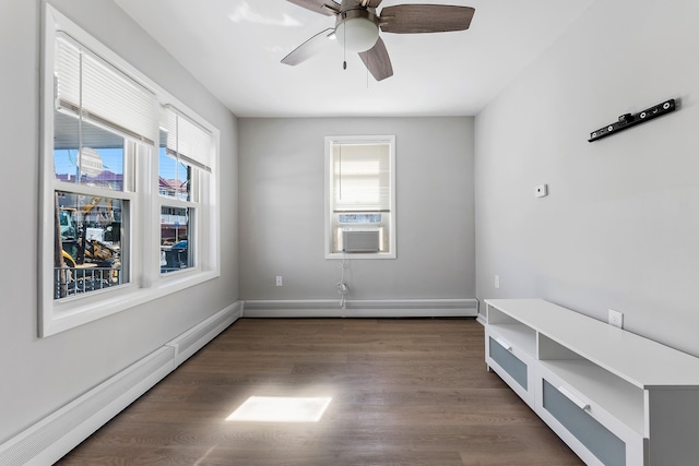 empty room with ceiling fan, cooling unit, dark wood-type flooring, and a baseboard heating unit