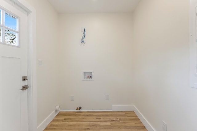 clothes washing area featuring washer hookup, hookup for a gas dryer, and light hardwood / wood-style flooring