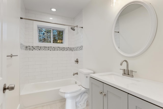 full bathroom featuring toilet, vanity, and tiled shower / bath