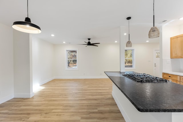 kitchen featuring gas cooktop, light wood-type flooring, hanging light fixtures, and ceiling fan