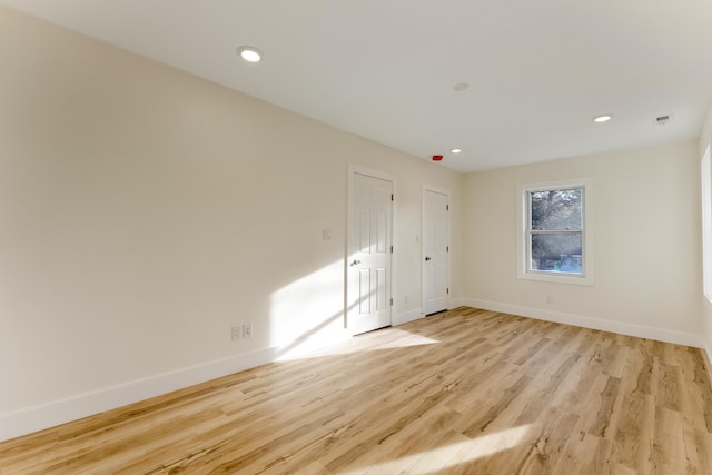 unfurnished room with light hardwood / wood-style flooring