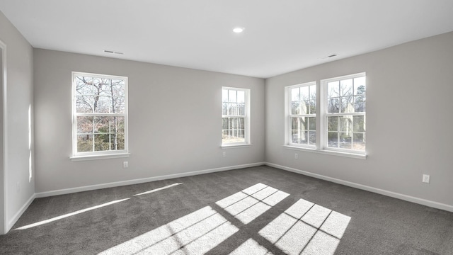 unfurnished room featuring dark carpet