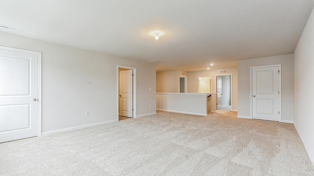 unfurnished living room featuring light carpet