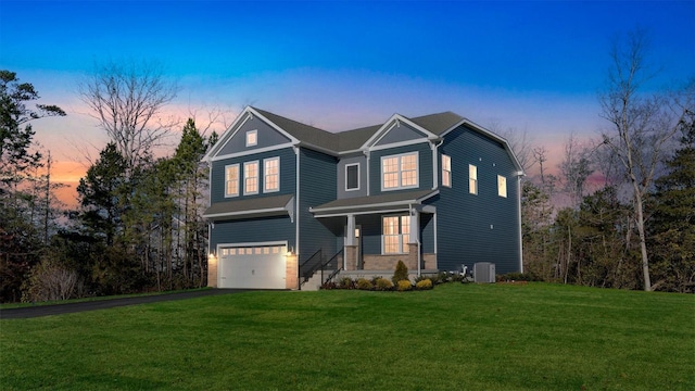 front of property with a lawn, cooling unit, and a garage