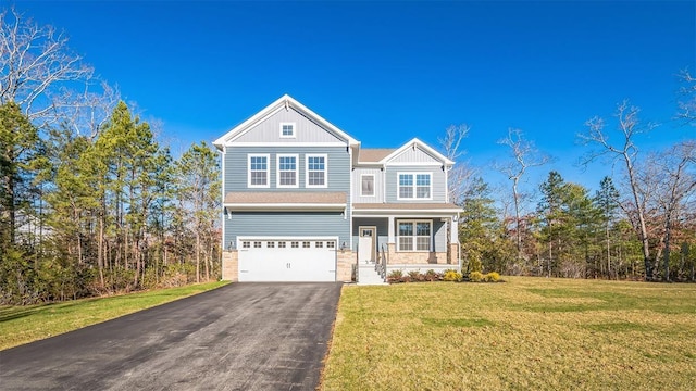 view of front of property featuring a porch, a garage, and a front lawn