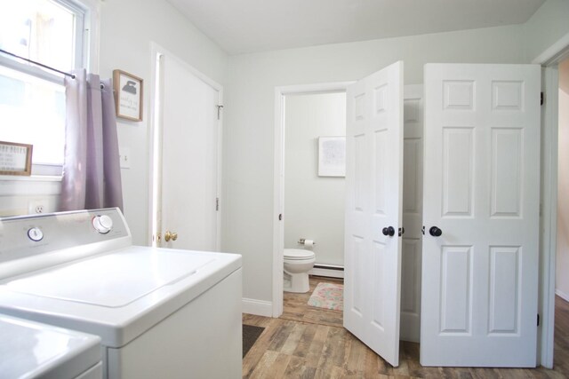 laundry area with hardwood / wood-style floors, plenty of natural light, independent washer and dryer, and a baseboard radiator