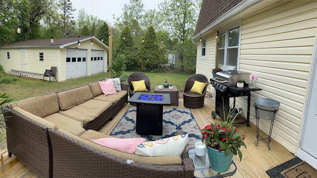 wooden deck featuring grilling area, an outdoor living space with a fire pit, an outdoor structure, and a garage