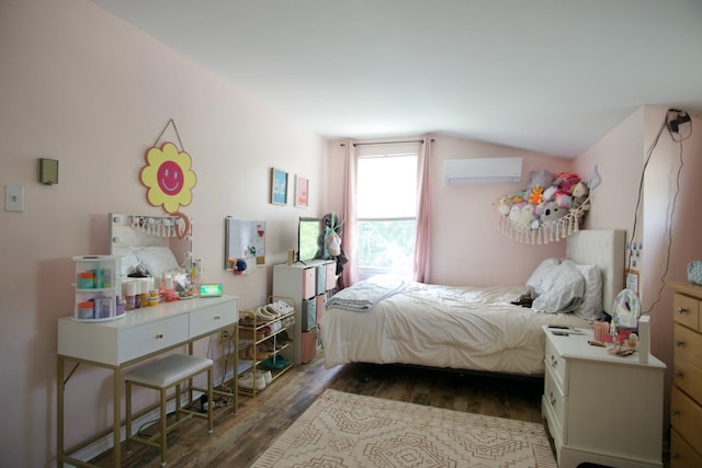 bedroom with a wall mounted air conditioner, dark hardwood / wood-style flooring, and vaulted ceiling