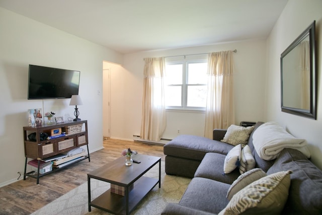 living room featuring light wood-type flooring and a baseboard heating unit