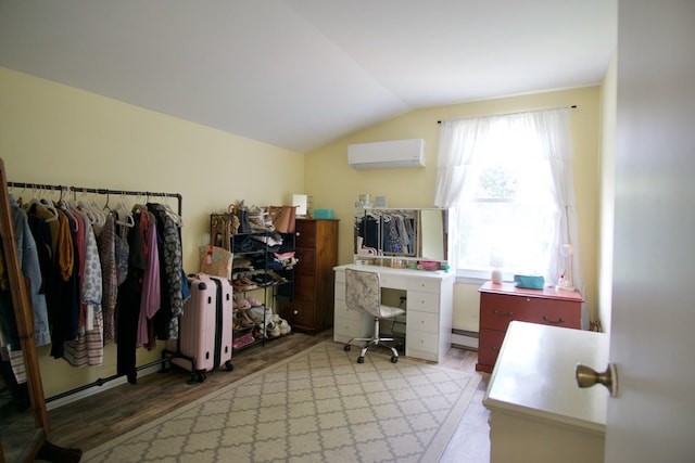 office space featuring radiator, vaulted ceiling, a baseboard heating unit, wood-type flooring, and an AC wall unit