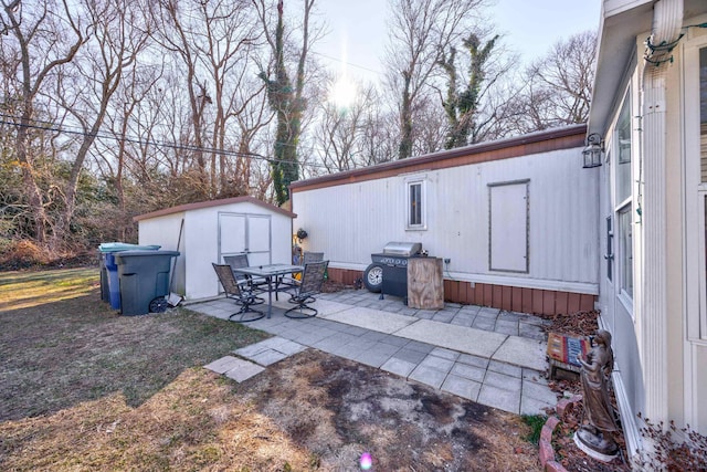 view of patio featuring a storage shed and an outdoor structure