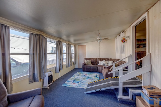 sunroom featuring an AC wall unit and a ceiling fan