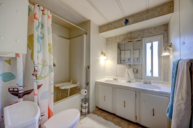 bathroom featuring double vanity, toilet, shower / bath combo, and a sink