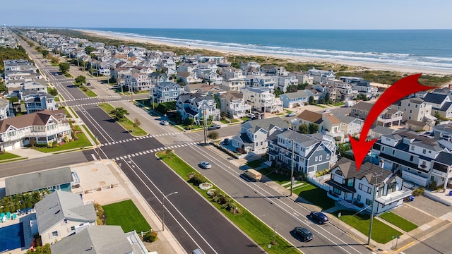 aerial view with a water view and a view of the beach