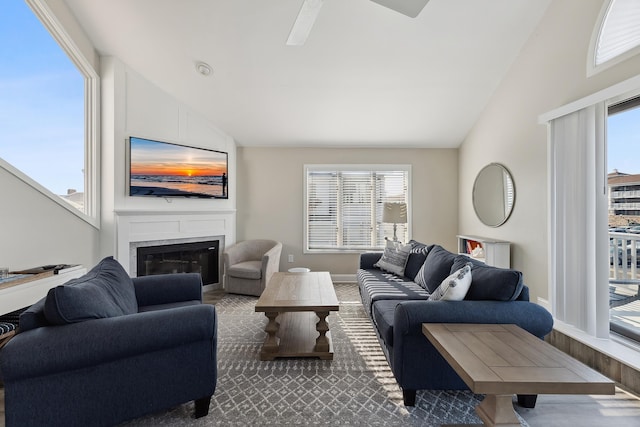 living room with carpet flooring, vaulted ceiling, and a healthy amount of sunlight