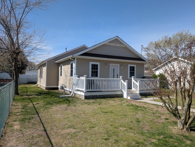 shotgun-style home featuring a wooden deck, a front yard, and fence
