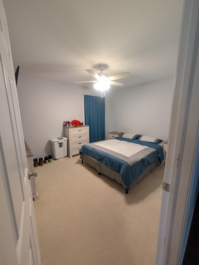 carpeted bedroom with a ceiling fan