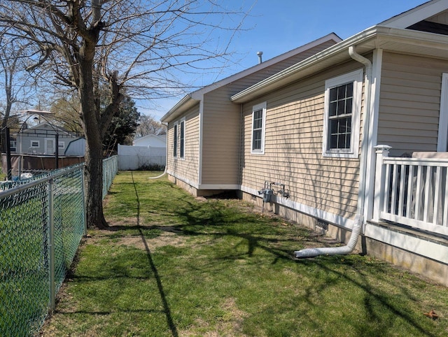view of home's exterior with a lawn and a fenced backyard