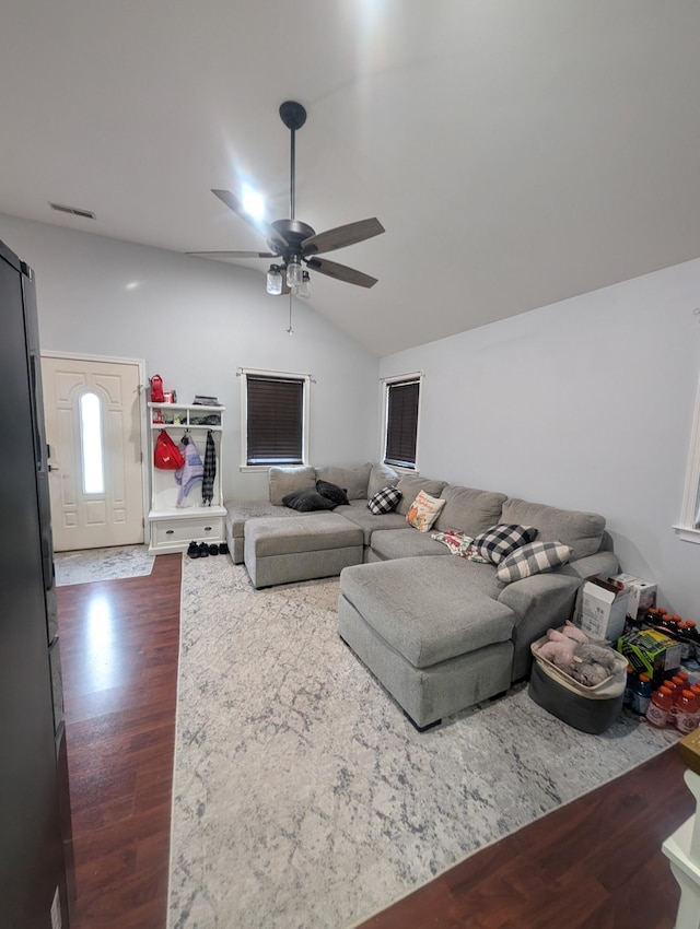 living room with dark wood finished floors, ceiling fan, lofted ceiling, and visible vents