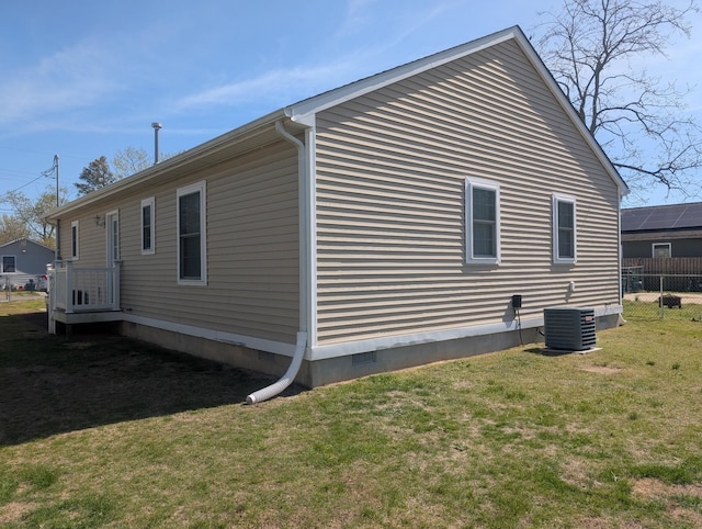 view of home's exterior featuring fence, crawl space, a yard, and central AC