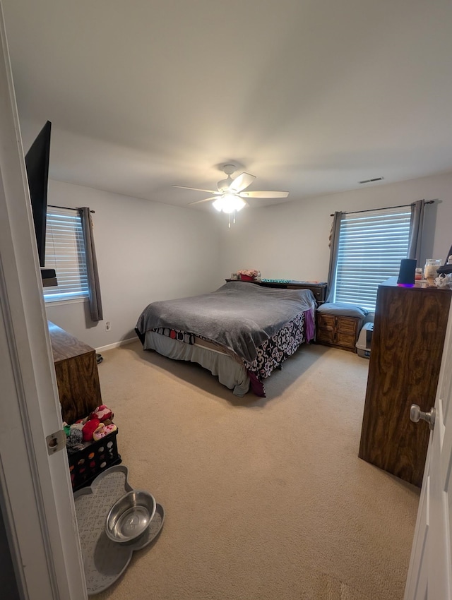bedroom featuring carpet, visible vents, and ceiling fan