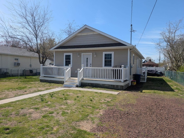 bungalow with a wooden deck, fence, and a front yard
