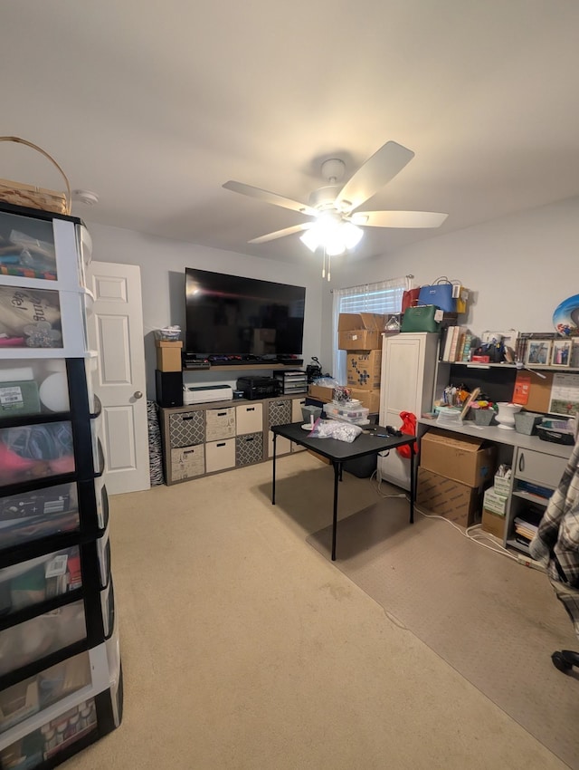 living area featuring carpet and ceiling fan