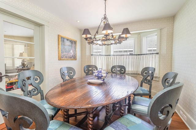 74 W 7th St, Avalon, NJ 08202 - dining room with wallpapered walls, a chandelier, wood finished floors, and healthy amount of natural light