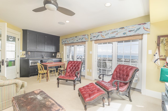 74 W 7th St, Avalon, NJ 08202 - living room featuring light colored carpet, healthy amount of natural light, a ceiling fan, recessed lighting, and a water view