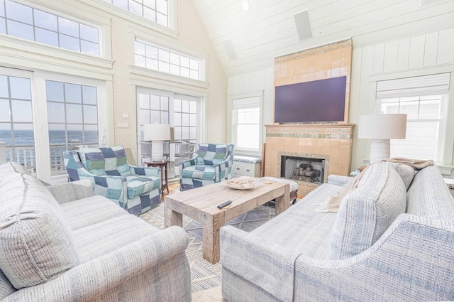 74 W 7th St, Avalon, NJ 08202 - living room featuring a tile fireplace and high vaulted ceiling