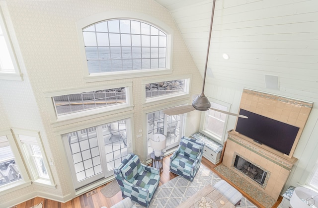 74 W 7th St, Avalon, NJ 08202 - living room with lofted ceiling, wood finished floors, and wallpapered walls