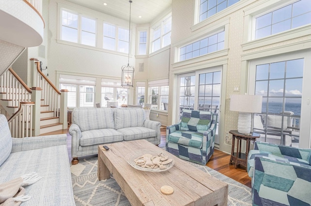 74 W 7th St, Avalon, NJ 08202 - living room with a high ceiling, wood finished floors, stairs, recessed lighting, and a chandelier