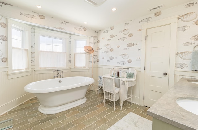 74 W 7th St, Avalon, NJ 08202 - bathroom with a wainscoted wall, a freestanding tub, double vanity, plenty of natural light, and recessed lighting