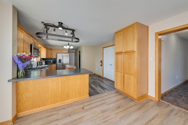15 4th Ave, Cape May Court House, NJ 08210 - kitchen with stainless steel appliances, a chandelier, a peninsula, and light wood-style floors