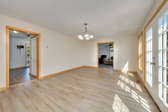 15 4th Ave, Cape May Court House, NJ 08210 - empty room with a chandelier, plenty of natural light, french doors, and light wood-style flooring