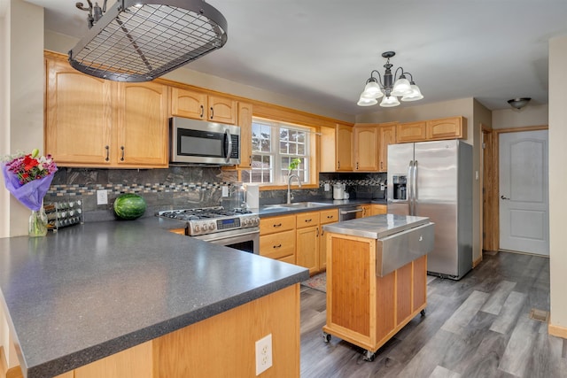 15 4th Ave, Cape May Court House, NJ 08210 - kitchen featuring stainless steel appliances, decorative backsplash, a chandelier, a peninsula, and dark countertops