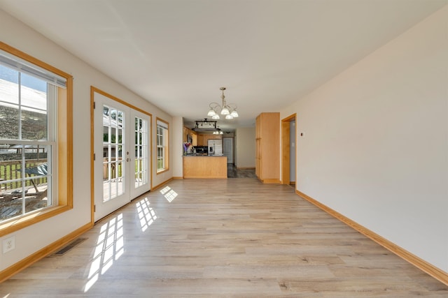 15 4th Ave, Cape May Court House, NJ 08210 - unfurnished dining area featuring a chandelier, light wood-type flooring, and french doors