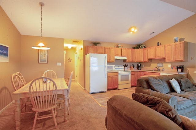 kitchen with light brown cabinets, white appliances, hanging light fixtures, and vaulted ceiling