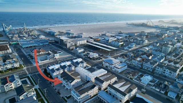 aerial view with a water view and a view of the beach