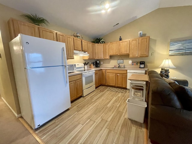 kitchen featuring white appliances, sink, vaulted ceiling, light wood-type flooring, and light brown cabinetry