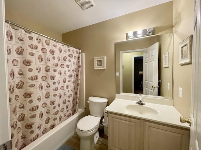 full bathroom featuring shower / tub combo, vanity, and toilet