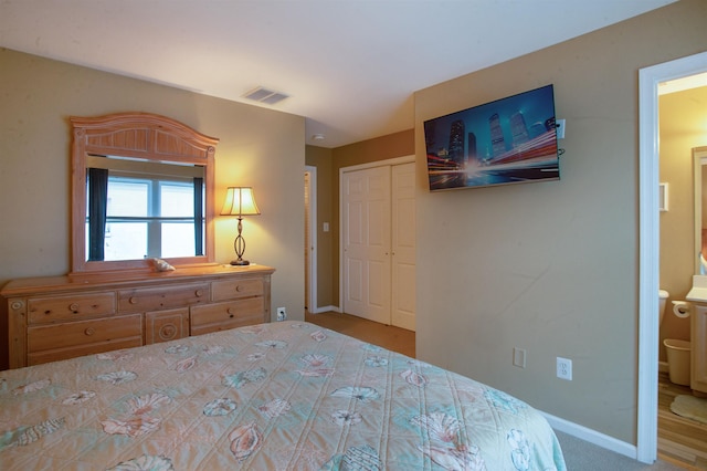 bedroom with connected bathroom and a closet