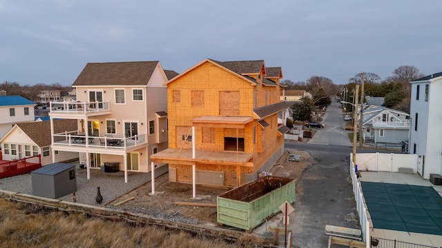 rear view of house with a garage and a balcony